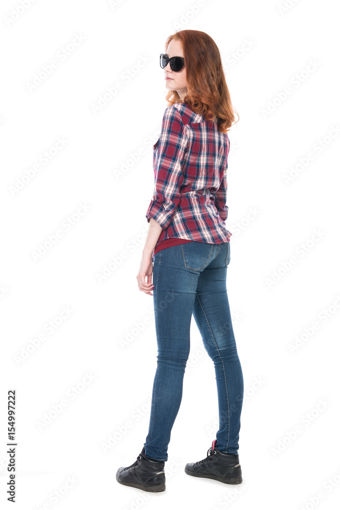 Young girl in a plaid shirt in full growth Young girl in a plaid shirt in full growth