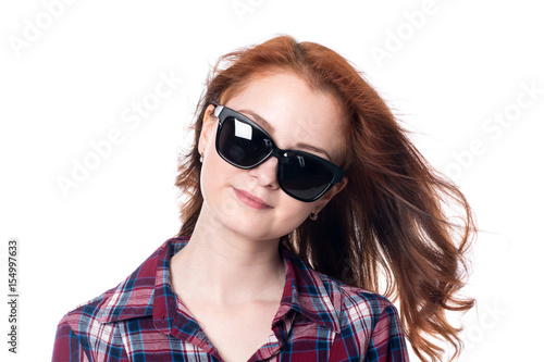 Close-up portrait of a red-haired beautiful woman wearing sunglasses