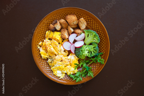 Home made fresh omelette for breakfast with vegetables vitamins. Broccoli omelette breakfast background. Fresh omelette with vitamins on plate. photo