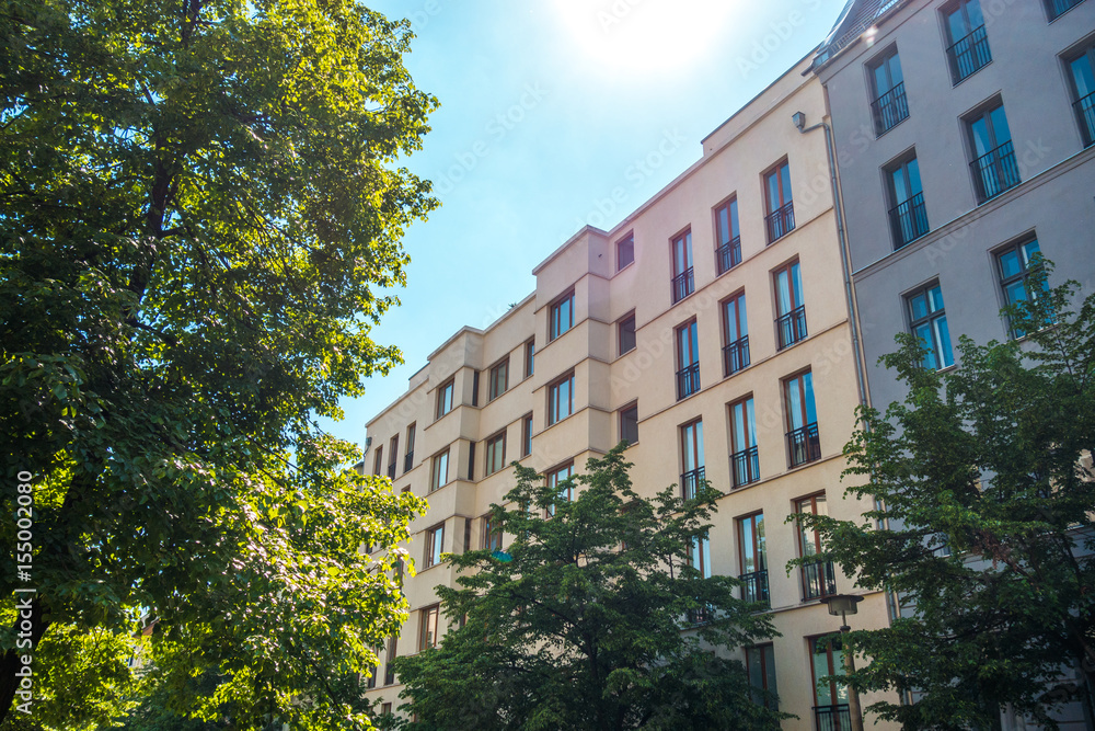 Fototapeta premium modern townhouses or apartment houses with green trees