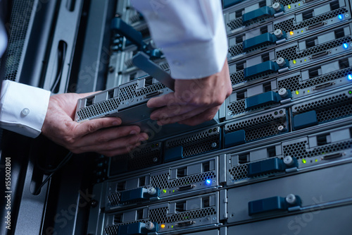 Plakat w ramie Blade server being held by an experienced engineer