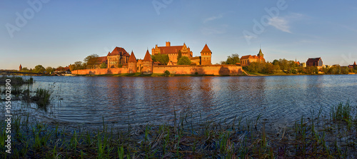 Malbork Castle in Poland, medieval fortress of Teutonic Knights Order, view across Nogat River, UNESCO World Heritage Site - panorama 