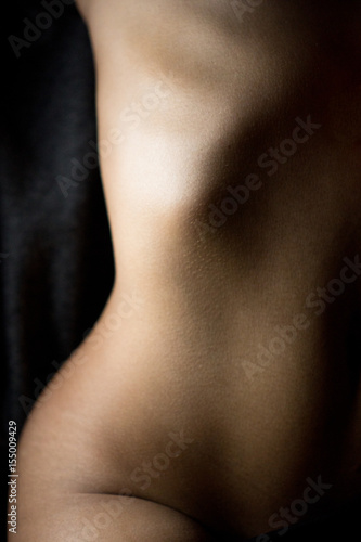 Crop naked female body photo