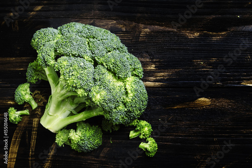 Wallpaper Mural Fresh broccoli on a dark wooden background, low key, top view Torontodigital.ca