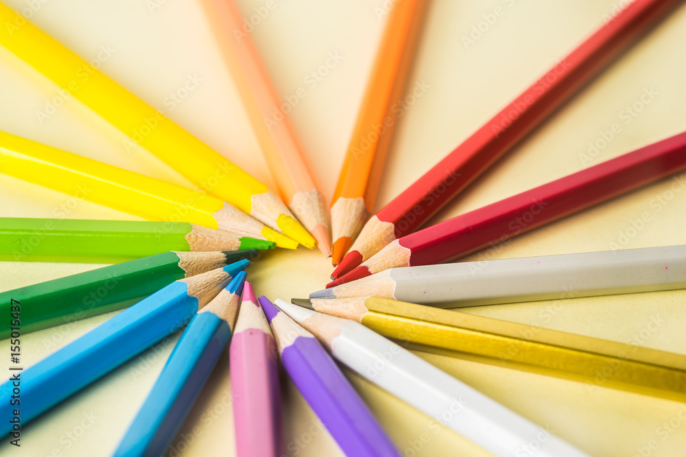 Business concept - Top view of color pencil circle on yellow paper background, teamwork, united and communication concept Business concept - Top view of color pencil circle on yellow paper background, teamwork, united and communication concept