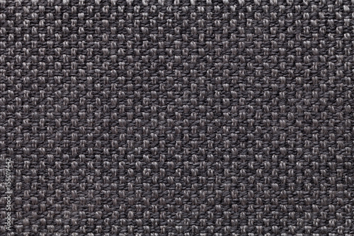Black textile background with checkered pattern, closeup. Structure of the fabric macro.