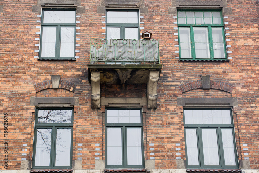 Vintage design windows with a balcony  on the facade of the old house
