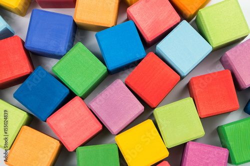 Flat lay of colorful wooden cubes as background. Top view.