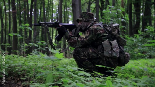 Wallpaper Mural Guerilla partisan warrior aiming in forest ambush carrying his gun. War battlefield maneuvers training. Torontodigital.ca