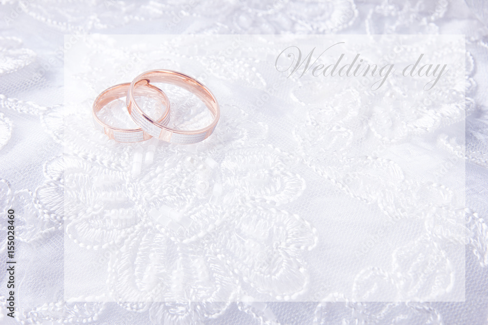 Wedding rings on wedding card, on a white wedding dress Wedding rings on wedding card, on a white wedding dress