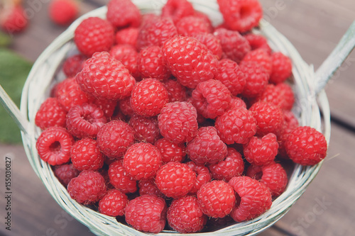 Basket with raspberries closeup, summer harvest