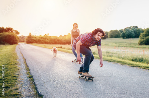 Skateboarding couple having fun/ Couple enjoying and skateboarding at nature