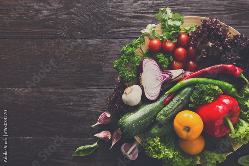 Plenty of fresh vegetables on wooden background with copy space