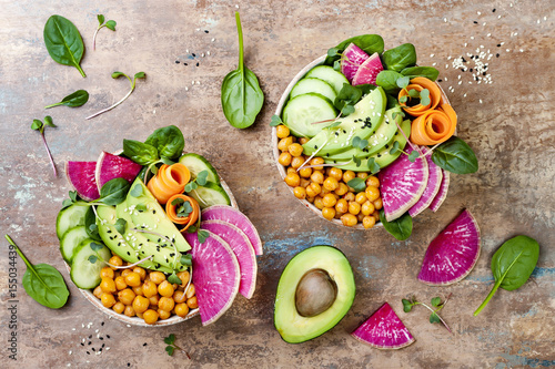 Vegan, detox Buddha bowl recipe with avocado, carrots, spinach, chickpeas and radishes. Top view, flat lay, copy space photo