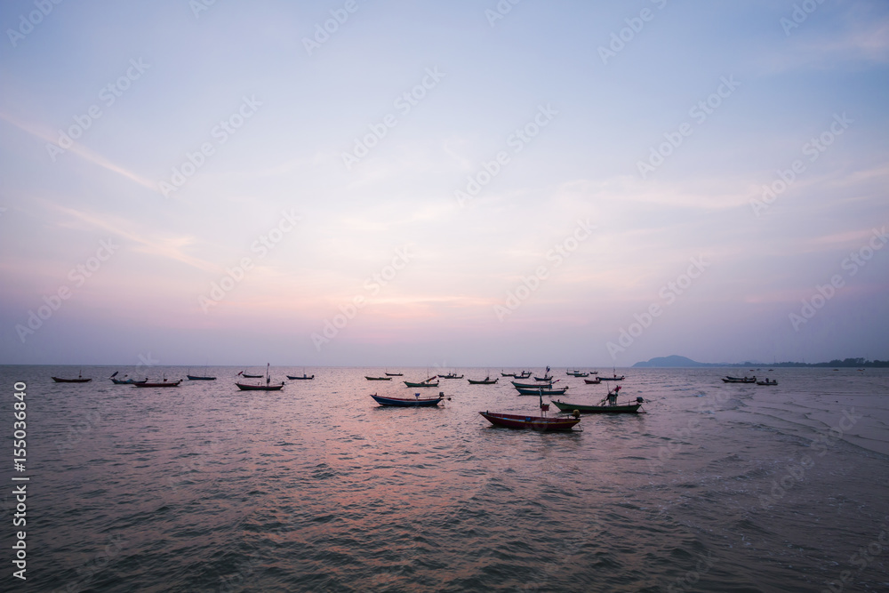 Sea locals fishing boats at sunset