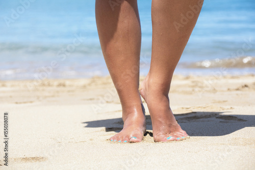Feet in the sand on the beach