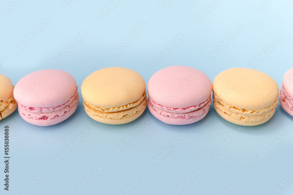 Sweet colorful macaroons on blue table background. Sweet colorful macaroons on blue table background.