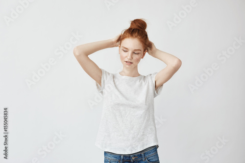 Young attractive girl touching her foxy hair. © Cookie Studio