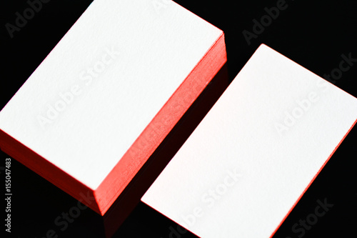 thick white cotton paper business card mock up with red painted edges. Blank business cards template.