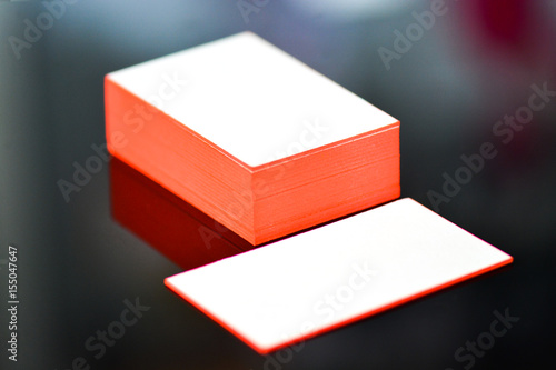 thick white cotton paper business card mock up with red painted edges. Blank business cards template.