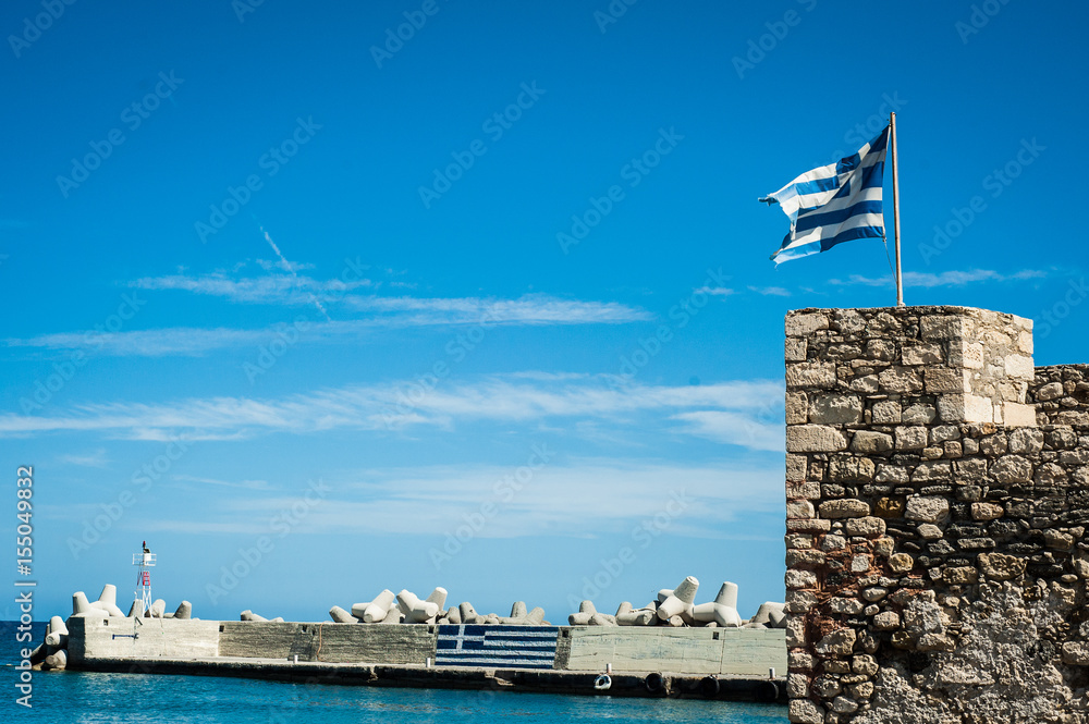 Greek flag on the top of fortifications. Greece, Crete, fortification