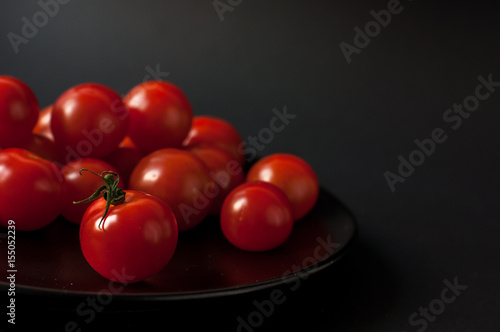Tomatoes on black background.