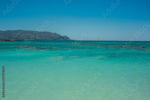 Obraz na płótnie Windsurfer on the turquoise water, Elafonisi pink beach Greece, Crete w salonie