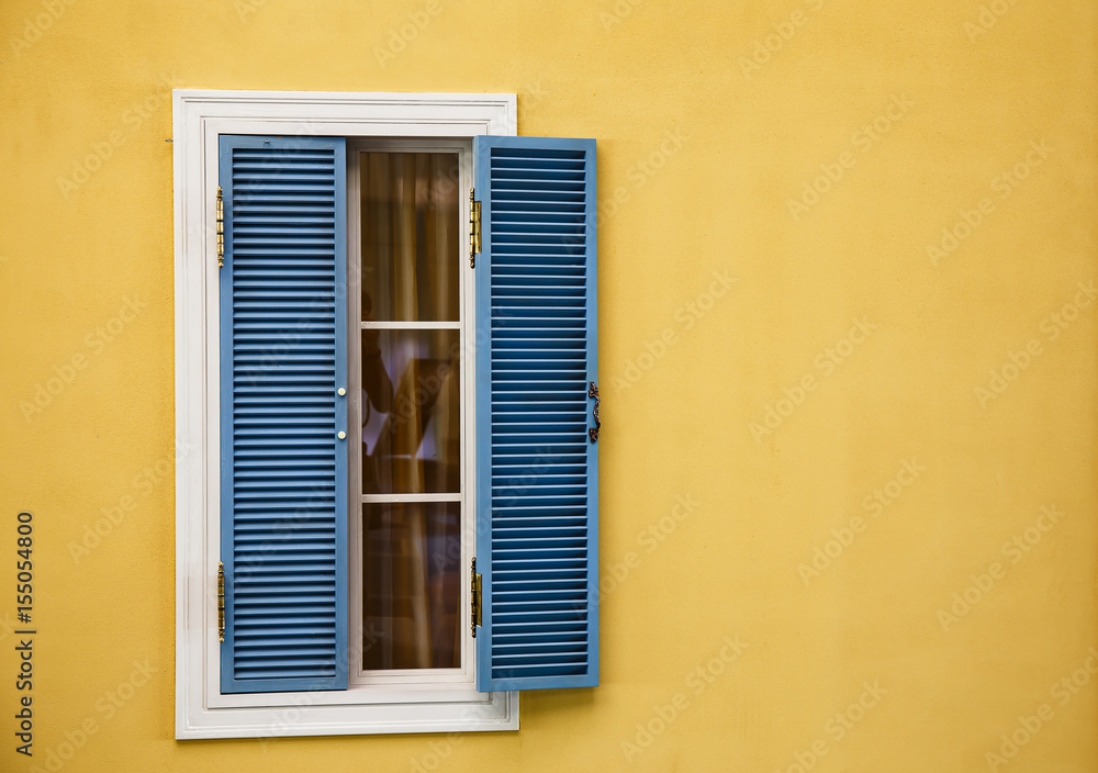 Wooden windows on yellow walls Wooden windows on yellow walls