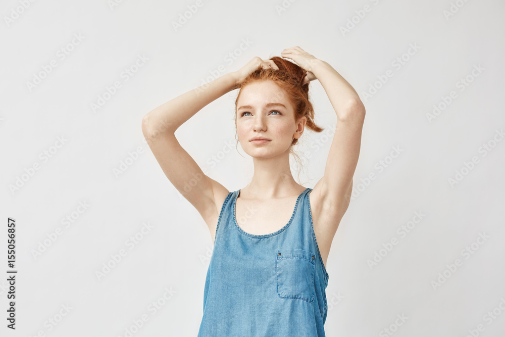 Young beautiful redhead girl correcting her haircut. Young beautiful redhead girl correcting her haircut.
