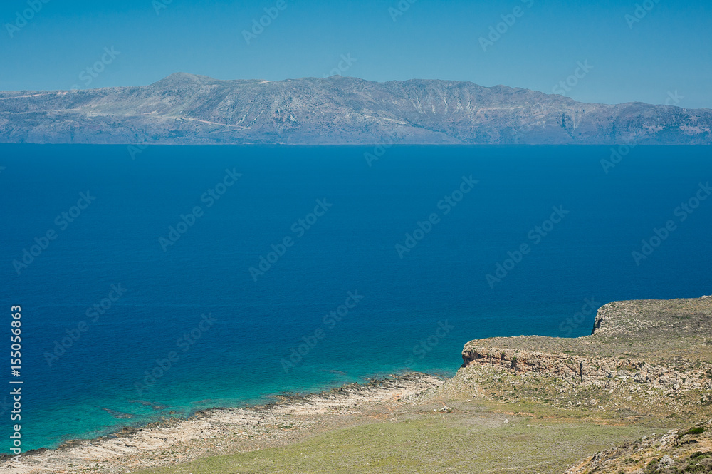 Sea coast, turquoise water and rocky hill. Road to Balos bay, Crete, Greece