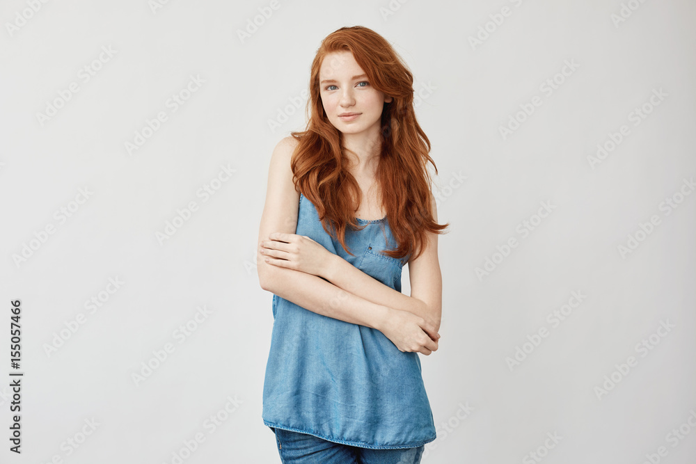 Beautiful fashion redhead model posing smiling looking at camera. Beautiful fashion redhead model posing smiling looking at camera.