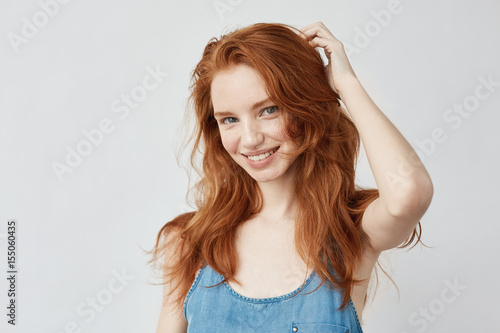 Emotive sincere happy girl with red hair smiling. Fototapet