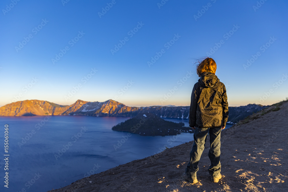Boy hiking around crater lake
