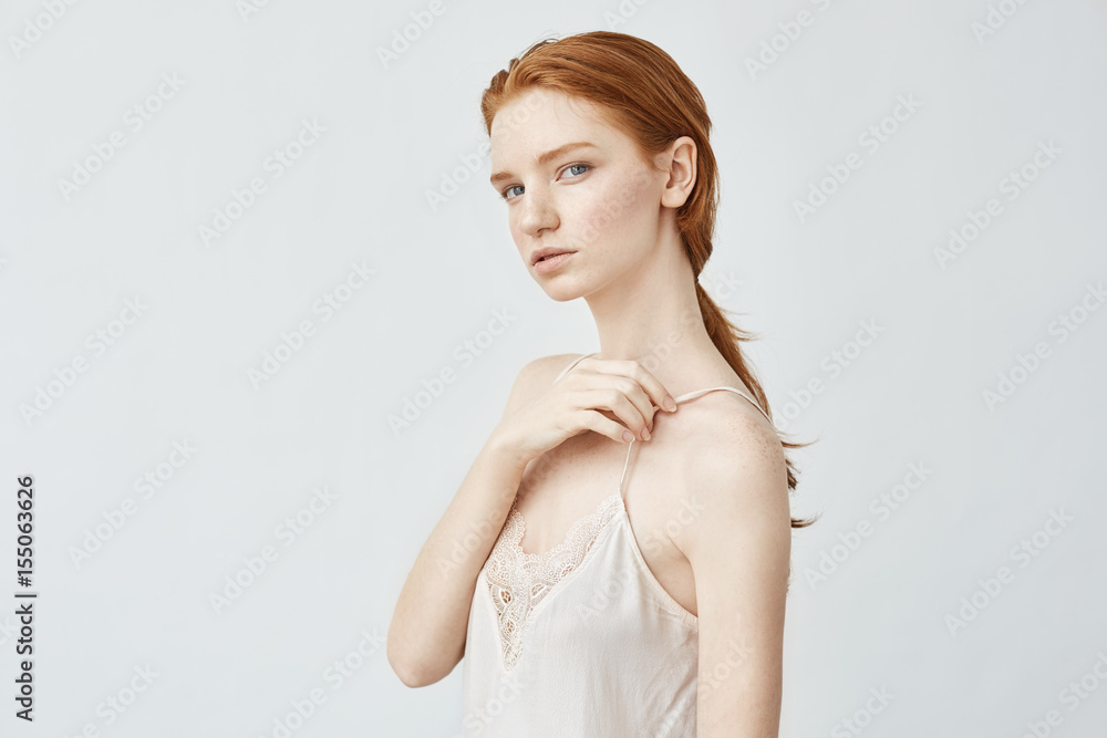 Portrait of beautiful redhead girl posing looking at camera. Portrait of beautiful redhead girl posing looking at camera.