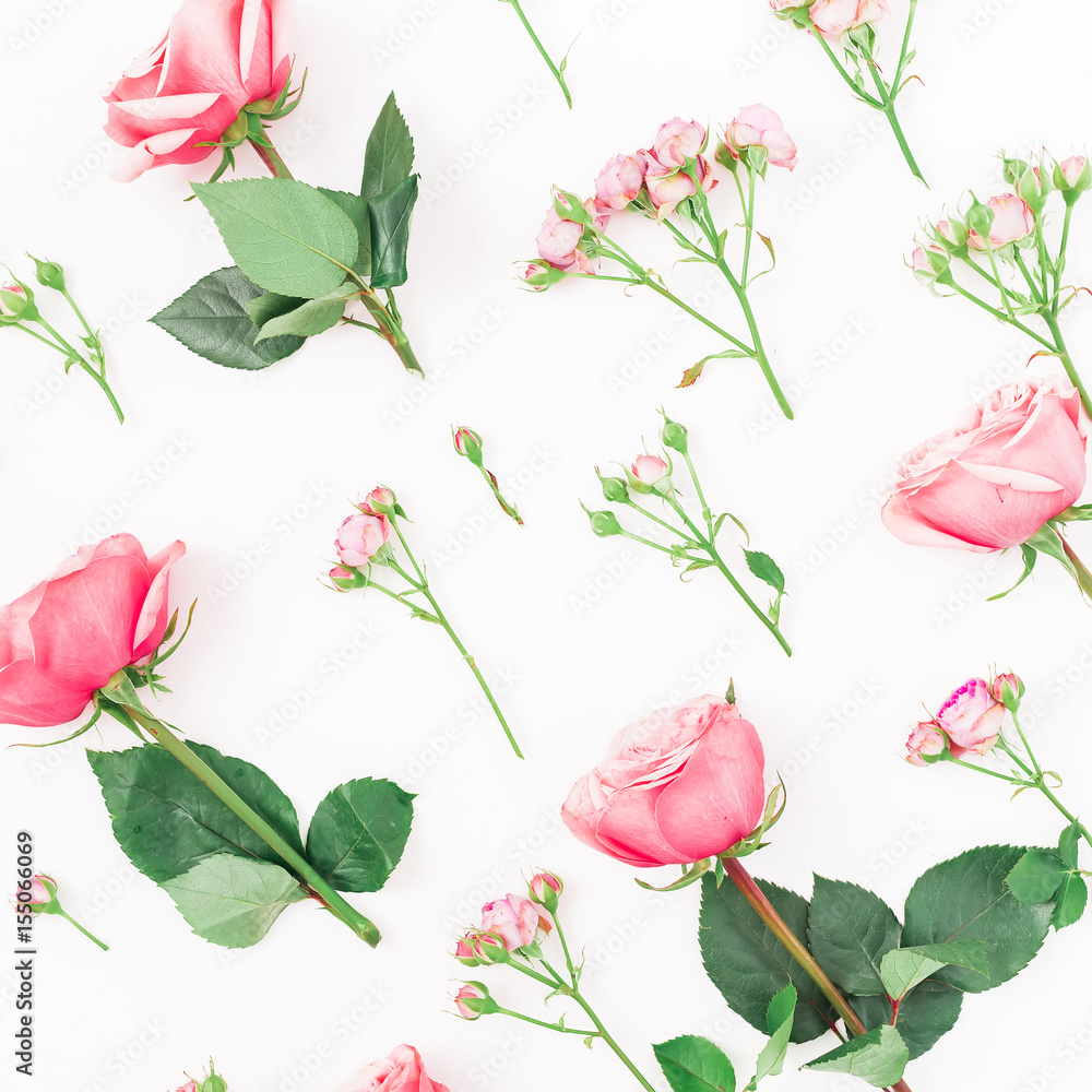 Pattern of pink or red roses, buds and leaves on white background. Flat lay, top view. Floral pattern