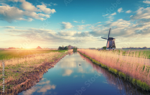 Windmills at sunrise. Rusti...