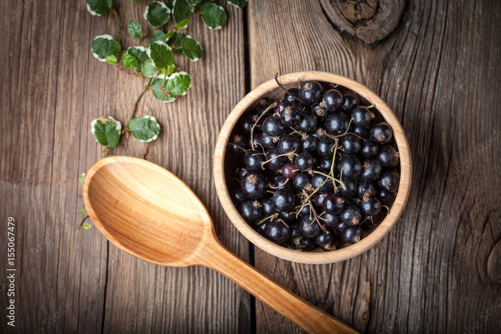 Blackcurrant in wooden bowl. Blackcurrant in wooden bowl.