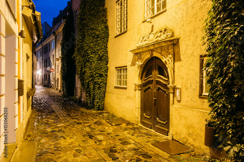 Riga, Latvia. Old Wooden Brown Door Of Portal, Decorated By Molding