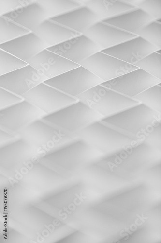 Closeup abstract white folded origami geometrical jigsaw paper pattern background
