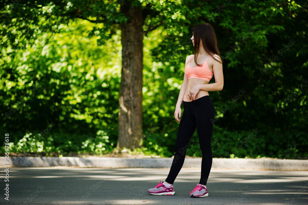 Fitness sport girl in sportswear posed at road in park, outdoor sports, urban style. Fitness sport girl in sportswear posed at road in park, outdoor sports, urban style.