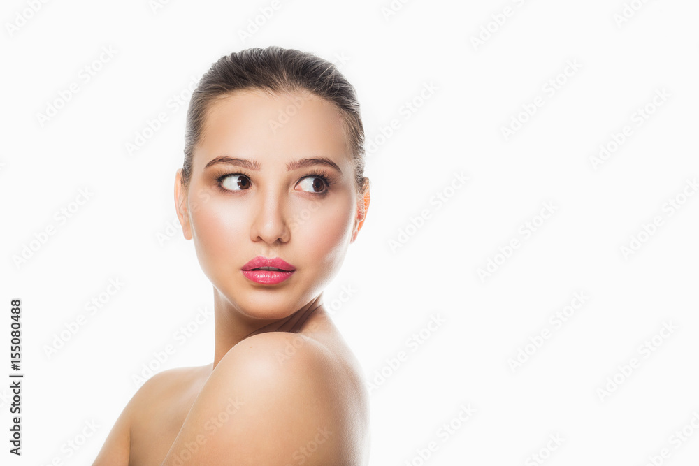 Beauty Spa Woman with perfect skin Portrait. Beautiful Brunette Spa Girl showing empty copy space on the open hand palm for text. Proposing a product. Gestures for advertisement. Beige background