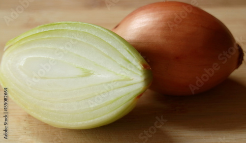 Fresh onion isolated on wood background