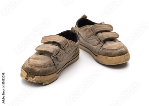 pair of old grey shoes on a white background