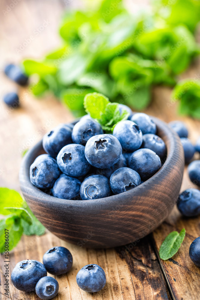 Fresh blueberries in bowl on wooden table Fresh blueberries in bowl on wooden table