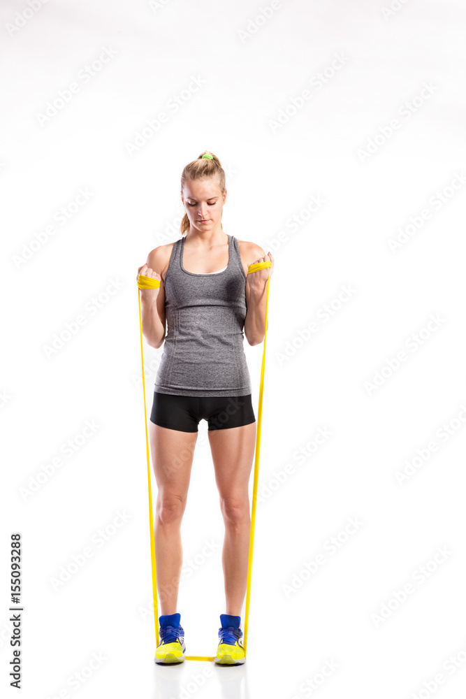 Young fitness woman with rubber bands. Studio shot. Young fitness woman with rubber bands. Studio shot.