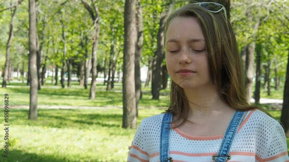 Girl with freckles in the park. Beautiful face of a teenager against a background of soap bubbles. Face with freckles. Girl with freckles in the park. Beautiful face of a teenager against a background of soap bubbles. Face with freckles.