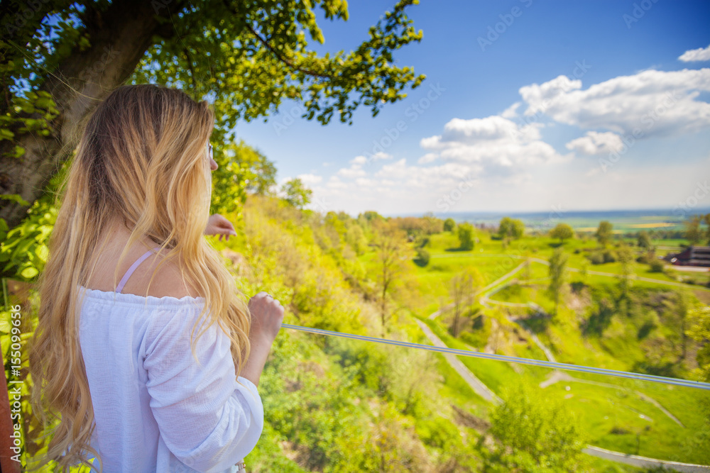 Girl on background of green meadow and hills Girl on background of green meadow and hills