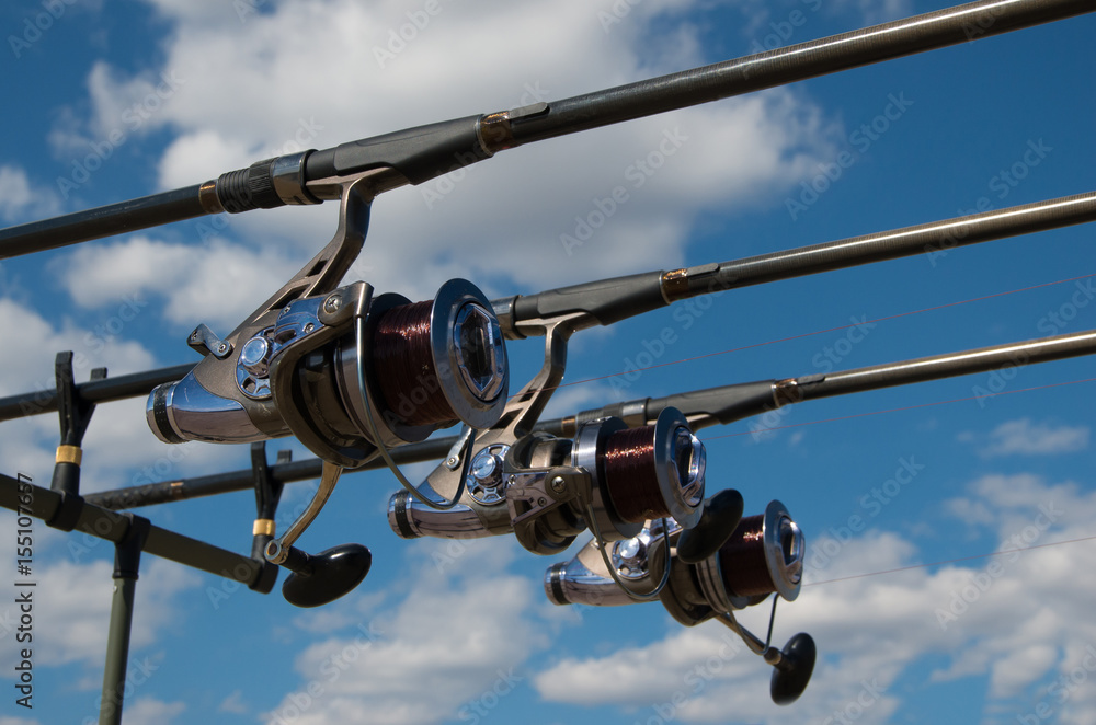 Equipment for carp fishing with three fishing rods with reels on a support  system - rod pod Stock Photo