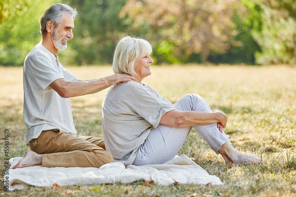 Fototapeta premium Old man gives a massage to his wife