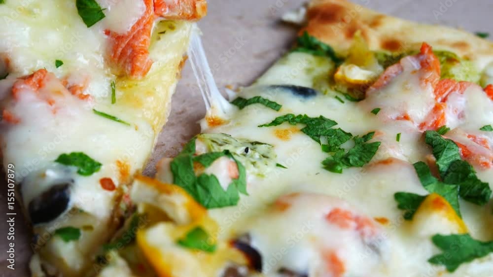 Hand Takes A Piece of Delicious Pizza Made of Fish, Green and Cheese, Vegetable Herbs, Parsley and Olives. Preheated Cheese Tends. Piece of Fish Pizza Take from Box Hand Takes A Piece of Delicious Pizza Made of Fish, Green and Cheese, Vegetable Herbs, Parsley and Olives. Preheated Cheese Tends. Piece of Fish Pizza Take from Box